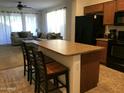 Open kitchen featuring an island with counter seating and modern appliances at 6191 S Pearl Dr, Chandler, AZ 85249