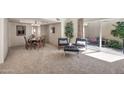 Elegant living space with modern seating, dining table, and sliding doors to the outdoors at 6226 N 21St Dr, Phoenix, AZ 85015