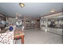 Spacious dining area with tile floors, decorative chair rail, and a bar area enhances the living space at 635 W Gable Ave, Mesa, AZ 85210