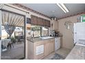 Cozy kitchen with light wood cabinets, white appliances, and a view of the backyard patio at 635 W Gable Ave, Mesa, AZ 85210