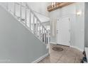 Inviting foyer with tile floors and a staircase leading to the second level of the home at 6422 W Range Mule Dr, Phoenix, AZ 85083