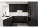 Modern kitchen featuring dark wood cabinets and marble countertops at 7167 E Rancho Vista Dr # 4010, Scottsdale, AZ 85251