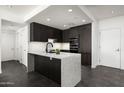 Modern kitchen features dark cabinets, marble countertops, and stainless appliances at 7167 E Rancho Vista Dr # 4010, Scottsdale, AZ 85251