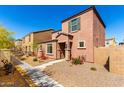 Quaint two-story home featuring a low-maintenance yard and covered porch at 8244 W Albeniz Pl, Phoenix, AZ 85043