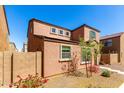 Side view of the property showing a well-maintained landscape with a block wall at 8244 W Albeniz Pl, Phoenix, AZ 85043