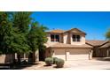 Charming two-story home with a well-manicured lawn and a two car garage at 9052 E Hobart St, Mesa, AZ 85207