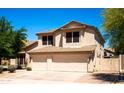 Charming two-story home with a well-manicured lawn and a two car garage at 9052 E Hobart St, Mesa, AZ 85207