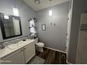 Bathroom showcases dark wood floors, white vanity, wall decor, and mosaic backsplash at 11596 W Sierra Dawn Blvd # 33, Surprise, AZ 85378