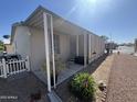 Charming home exterior featuring a cozy covered porch and well-maintained landscaping at 11596 W Sierra Dawn Blvd # 33, Surprise, AZ 85378