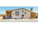 Exterior of home featuring desert-themed decor, gravel landscaping, and an enclosed porch at 11596 W Sierra Dawn Blvd # 33, Surprise, AZ 85378