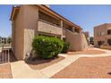 Exterior shot showing the complex's well maintained stucco walls and desert landscaping at 11666 N 28Th Dr # 295, Phoenix, AZ 85029