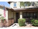 Inviting front porch with a ceiling fan and space for seating to enjoy the outdoors at 13686 N 151St Dr, Surprise, AZ 85379