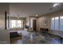 Bright, neutral living room showcasing hardwood floors, large windows with bright shutters and comfortable seating at 14045 E Geronimo Rd, Scottsdale, AZ 85259