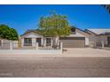 Charming single-Gathering home featuring well-maintained landscaping, a spacious driveway, and a welcoming two-car garage at 1408 E Carson Rd, Phoenix, AZ 85042
