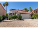 Charming home featuring a red tile roof, two-car garage, and drought-resistant landscaping at 1425 E Commerce Ave, Gilbert, AZ 85234
