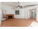 Inviting living room with a cozy brick fireplace and tile flooring at 1425 E Commerce Ave, Gilbert, AZ 85234