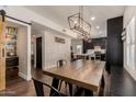 Dining room space featuring a rustic table with a view into the modern kitchen at 1631 N Avoca --, Mesa, AZ 85207