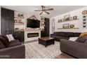 Comfortable living room features a fireplace, built in storage, and floating shelves at 1631 N Avoca --, Mesa, AZ 85207