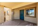 Welcoming entryway featuring a secure teal door and window, creating a bright, inviting entrance at 2220 W Dora St # 220, Mesa, AZ 85201