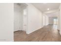 Inviting entryway with hardwood floors, white walls, and ample natural light at 25221 N 131St Dr, Peoria, AZ 85383