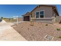 A single-Gathering home with desert landscaping and a two-car garage with a paver driveway at 25319 N 131St Dr, Peoria, AZ 85383