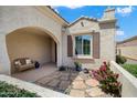 Inviting entryway with seating, desert landscaping, and stone tile walkway at 26456 W Cat Balue Dr, Buckeye, AZ 85396