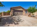 Single-story house with stucco and stone exterior, desert landscaping, and a spacious driveway at 29703 N 70Th Ave, Peoria, AZ 85383