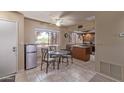 Dining room with tile flooring, island with sink, and a mini refrigerator at 4303 E Cactus Rd # 202, Phoenix, AZ 85032
