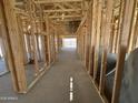 Interior view of new home construction with exposed wood framing and concrete slab at 47219 W Pecan Woods --, Maricopa, AZ 85139