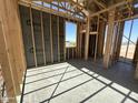Interior view of framed room under construction with visible insulation and window framing at 47219 W Pecan Woods --, Maricopa, AZ 85139