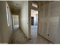 Open hallway view reveals smooth drywall, window light, and future access to multiple rooms at 47219 W Pecan Woods --, Maricopa, AZ 85139