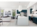 Open-concept living space with a stylish kitchen, comfortable seating area, and abundant natural light at 491 E Aurora Dr, San Tan Valley, AZ 85140