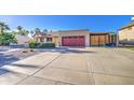 Long concrete driveway leading to a two-car garage and a private gated parking area at 538 E Rockwood Dr, Phoenix, AZ 85024