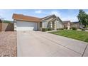 Exterior shot of a well-kept home with a long driveway and attached two car garage at 6335 E Brown Rd # 1065, Mesa, AZ 85205