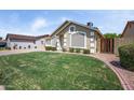 Quaint single-story home with well-manicured lawn and neutral-toned facade at 6335 E Brown Rd # 1065, Mesa, AZ 85205