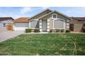 Charming single-story home featuring a well-maintained lawn and attached garage at 6335 E Brown Rd # 1065, Mesa, AZ 85205