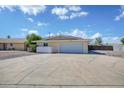 Single story home with a spacious driveway and attached two car garage at 7001 E Flossmoor Ave, Mesa, AZ 85208