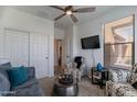 Bright living space featuring a ceiling fan, carpet, and a large flatscreen tv at 720 E Cobble Stone Dr, Queen Creek, AZ 85140