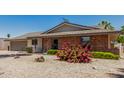 Charming home with brick accents and desert landscaping in the front yard at 855 S Revolta Cir, Mesa, AZ 85208