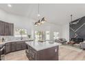 Open-concept kitchen with a view of the backyard and a cozy living area at 862 W Rawhide Ave, Gilbert, AZ 85233