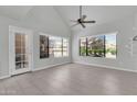 Bright living room featuring tile floors, a ceiling fan, and large windows offering plenty of natural light at 1001 N Pasadena Dr # 105, Mesa, AZ 85201