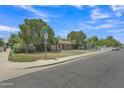 A well-manicured front yard and landscaping enhances this attractive corner lot property at 101 W 8Th Pl, Mesa, AZ 85201