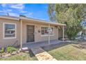 Inviting covered front porch with brick walkway and secure front door at 101 W 8Th Pl, Mesa, AZ 85201