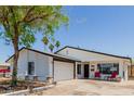 Charming single-story home with a well-manicured lawn, covered front porch, and attached two car garage at 1017 S San Jose Cir, Mesa, AZ 85202