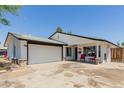 Charming single-story home with a well-manicured lawn, covered front porch, and attached two car garage at 1017 S San Jose Cir, Mesa, AZ 85202