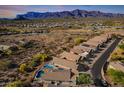 Aerial view of desert community with mountain views and neighborhood pool at 10276 E Meandering Trail Ln, Gold Canyon, AZ 85118