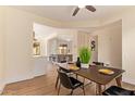Dining room with views to the kitchen with wood floors and modern decor at 10276 E Meandering Trail Ln, Gold Canyon, AZ 85118