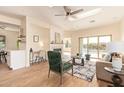 Bright living room with skylights, fireplace, and sliding glass doors with views of the backyard at 10276 E Meandering Trail Ln, Gold Canyon, AZ 85118