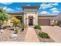 Charming single-story home with desert landscaping, a decorative entrance, and a two-car garage at 12027 S 183Rd Dr, Goodyear, AZ 85338