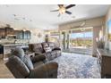 Open-concept living area flows seamlessly to the kitchen, featuring comfortable seating and natural light at 12027 S 183Rd Dr, Goodyear, AZ 85338